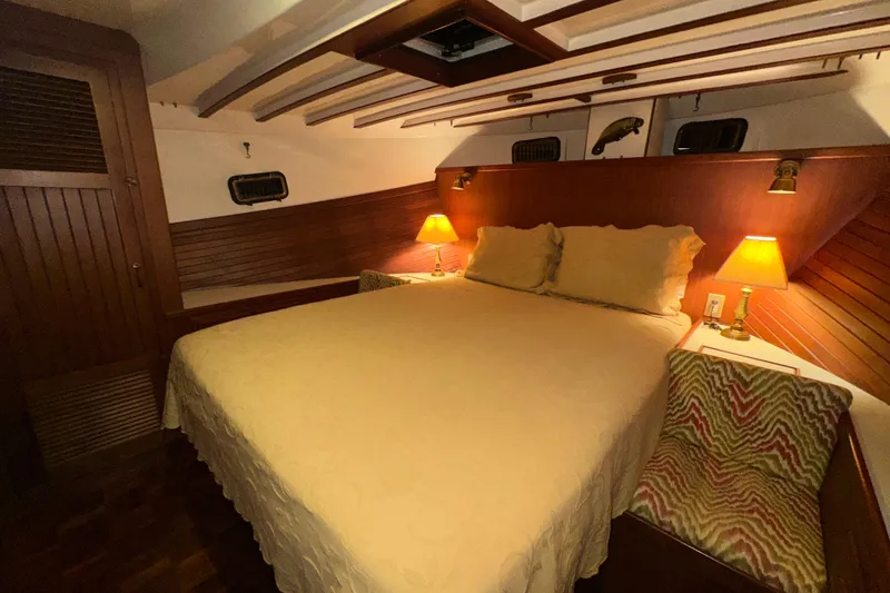 Slide: The Image of Cozy bedroom in 1987 Kadey-Krogen Manatee 36 yacht with warm lighting and wood paneling. - 49
