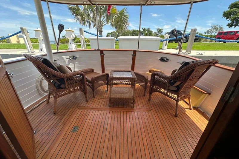 Slide: The Image of 1987 Kadey-Krogen Manatee 36 yacht deck with wicker chairs and table, docked outdoors. - 5
