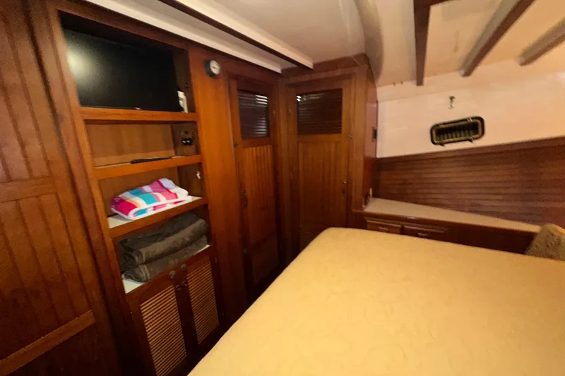 Slide: The Image of Cozy cabin interior of 1987 Kadey-Krogen Manatee 36 with wooden storage and bedding. - 50
