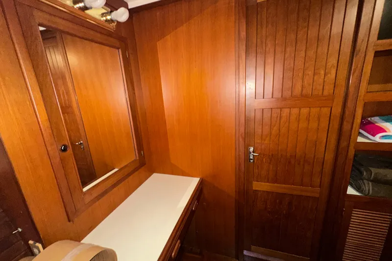 Slide: The Image of 1987 Kadey-Krogen Manatee 36 interior with wooden cabinetry and mirror. - 51