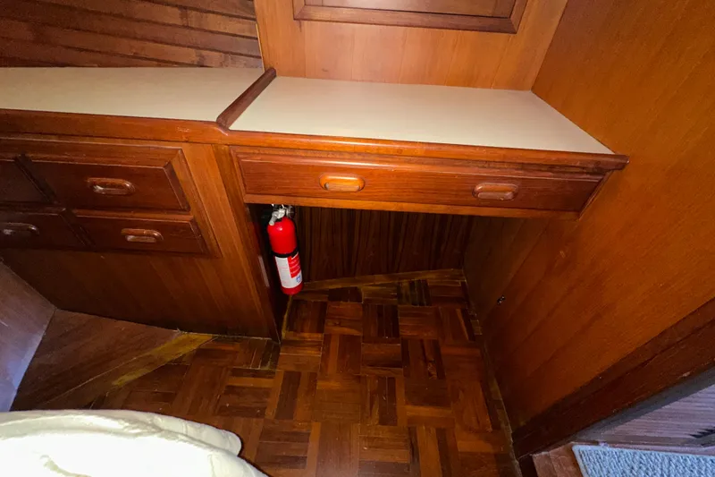 Slide: The Image of 1987 Kadey-Krogen Manatee 36 interior with wooden cabinetry and fire extinguisher. - 54