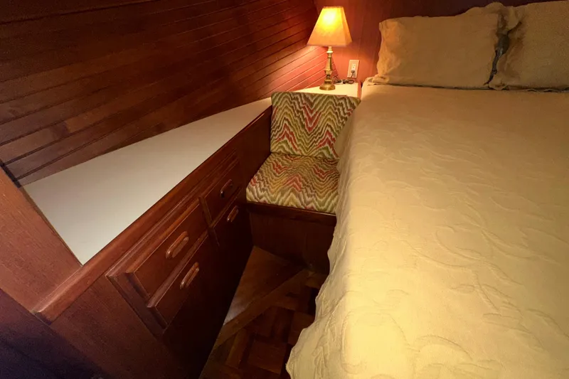 Slide: The Image of Cozy cabin interior of 1987 Kadey-Krogen Manatee 36 with wooden drawers and lamp. - 56