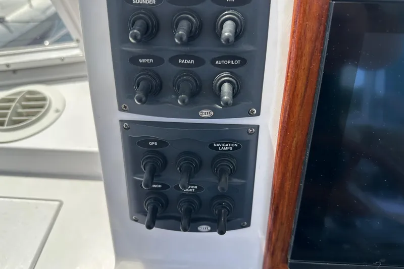 Slide: The Image of Control panel of a 1987 Kadey-Krogen Manatee 36 boat with switches for navigation. - 62