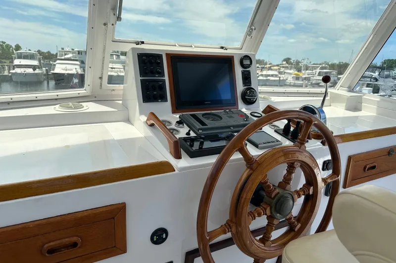 Slide: The Image of 1987 Kadey-Krogen Manatee 36 helm with wooden wheel and navigation equipment. - 68