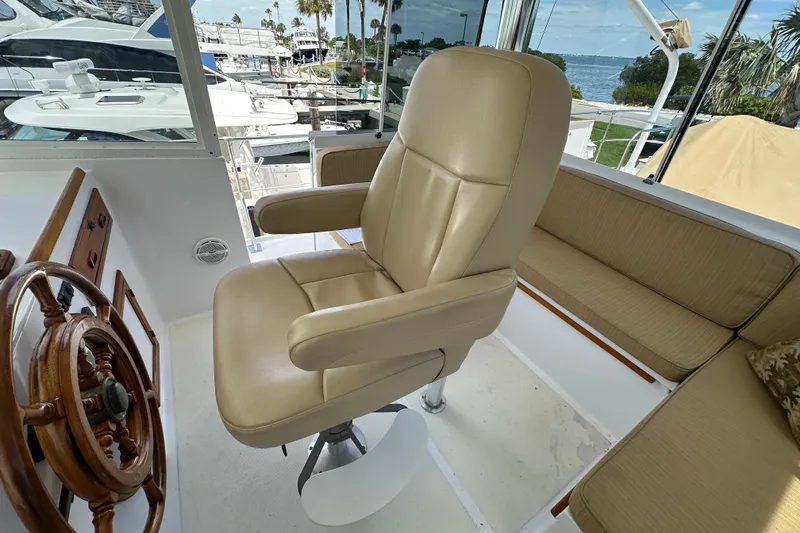 Slide: The Image of Captain's chair and helm on 1987 Kadey-Krogen Manatee 36 yacht, docked at marina. - 69