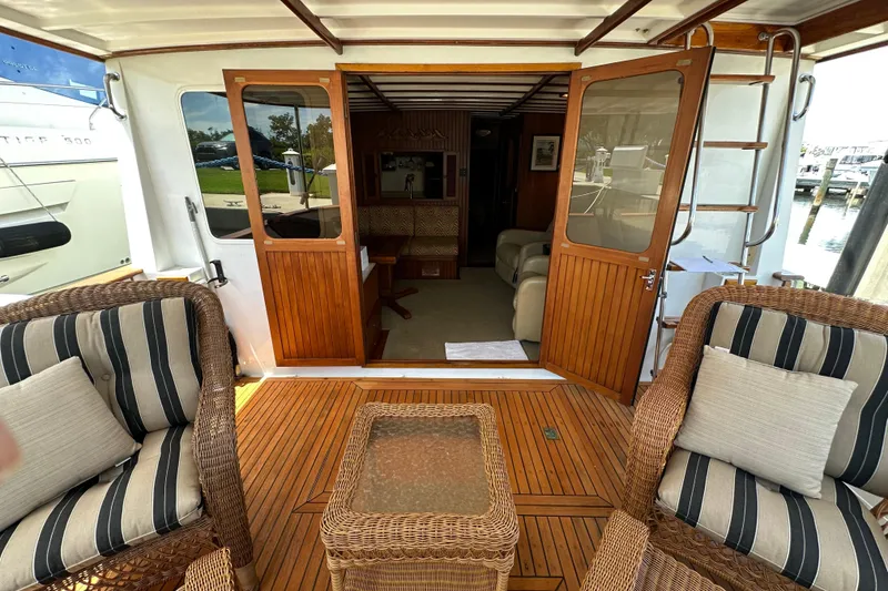 Slide: The Image of 1987 Kadey-Krogen Manatee 36 yacht interior with wicker seating and wooden doors. - 7