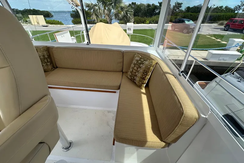 Slide: The Image of 1987 Kadey-Krogen Manatee 36 boat interior with beige seating and decorative pillows. - 70