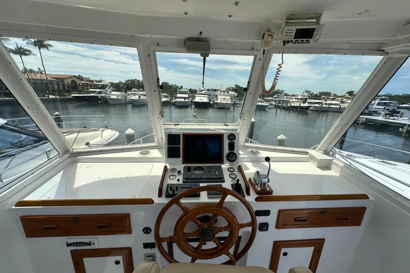 Slide: The Image of Helm of 1987 Kadey-Krogen Manatee 36 yacht with marina view. - 72