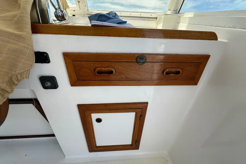 Slide: The Image of Wooden cabinetry on 1987 Kadey-Krogen Manatee 36 boat interior, featuring drawers and panel. - 77