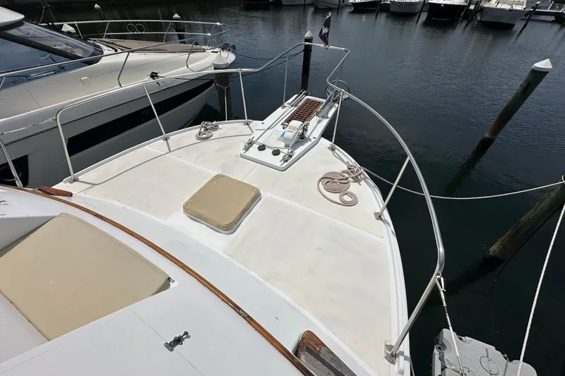 Slide: The Image of 1987 Kadey-Krogen Manatee 36 yacht deck, docked at marina with nearby boats. - 79