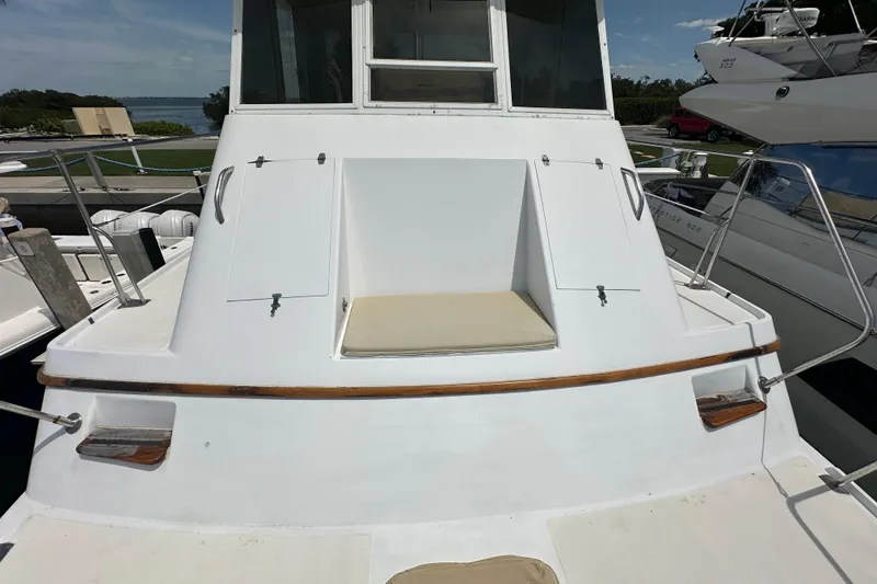 Slide: The Image of 1987 Kadey-Krogen Manatee 36 yacht, docked, showcasing rear deck and seating area. - 80