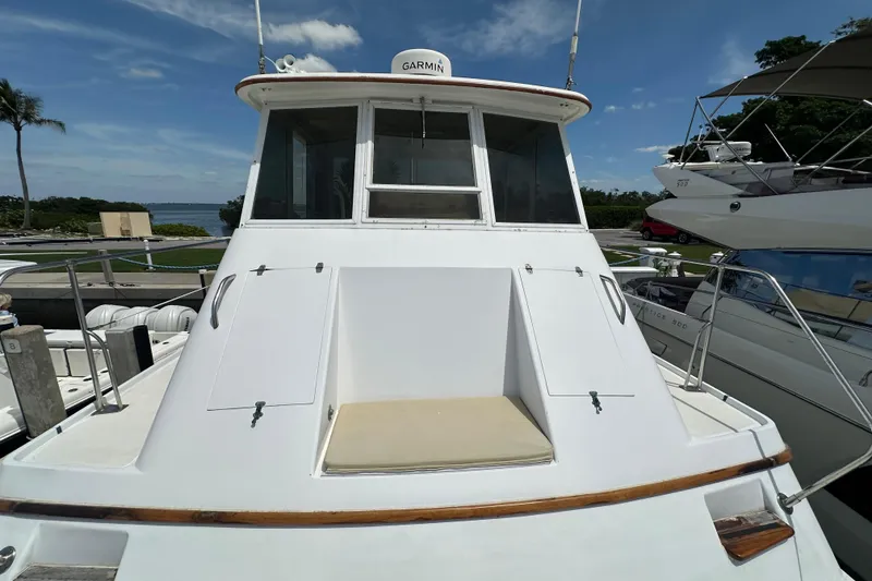 Slide: The Image of 1987 Kadey-Krogen Manatee 36 yacht docked, featuring a Garmin navigation system. - 81