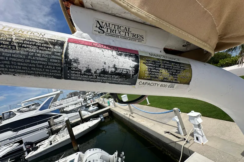 Slide: The Image of Boat davit with caution and maintenance labels, Kadey-Krogen Manatee 36, 1987 model. - 86