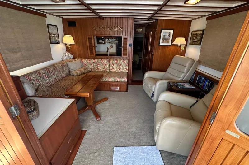 Slide: The Image of Interior of 1987 Kadey-Krogen Manatee 36 yacht with cozy seating and wooden accents. - 9