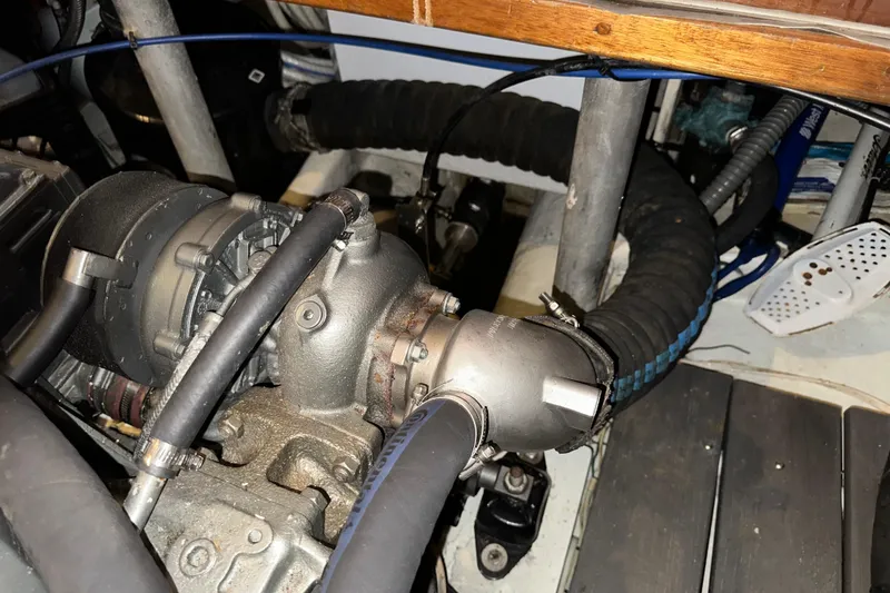 Slide: The Image of Engine compartment of a 1987 Kadey-Krogen Manatee 36 boat, showing mechanical components and hoses. - 96