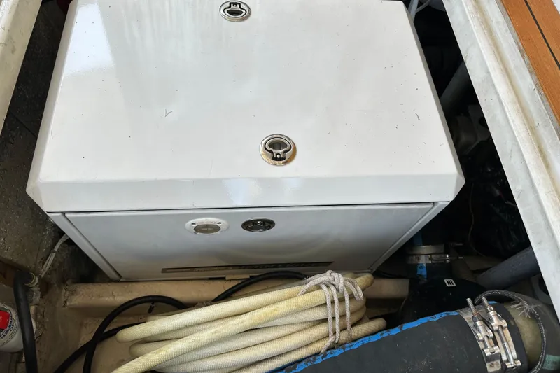 Slide: The Image of Engine compartment of a 1987 Kadey-Krogen Manatee 36 with hoses and equipment. - 97