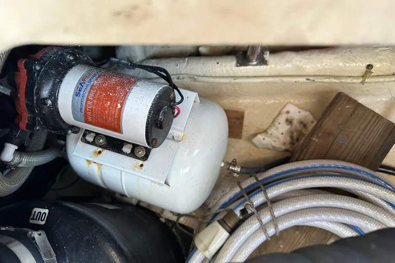 Slide: The Image of Engine compartment of a 1987 Kadey-Krogen Manatee 36 with water pressure system components. - 99