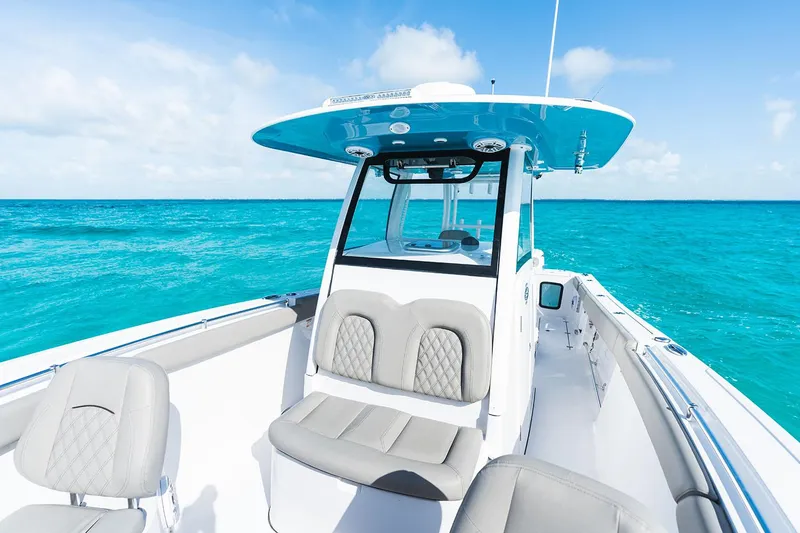 Slide: The Image of Manufacturer Provided Image: 2025 Sportsman Open 302 Center Console boat on clear turquoise water. - 4