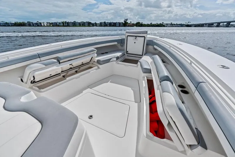 Slide: The Image of 2018 Regulator 41 boat interior with seating and storage, on a calm waterway. - 16