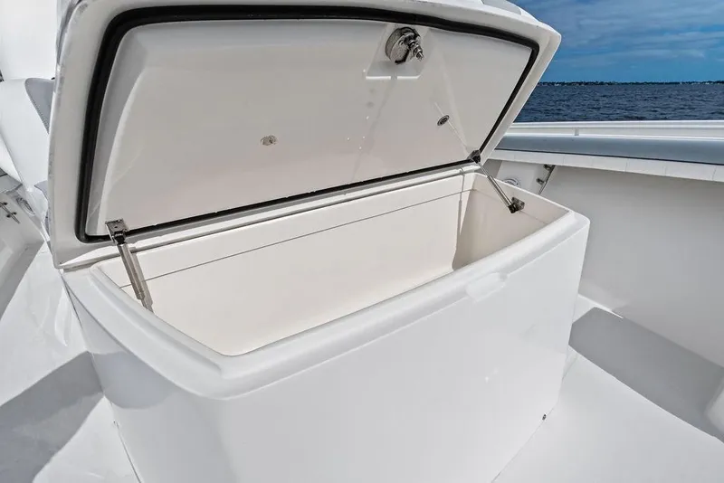 Slide: The Image of Open storage compartment on 2018 Regulator 41 boat, with ocean view in background. - 19
