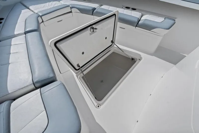 Slide: The Image of 2018 Regulator 41 boat interior with open storage compartment and cushioned seating. - 20