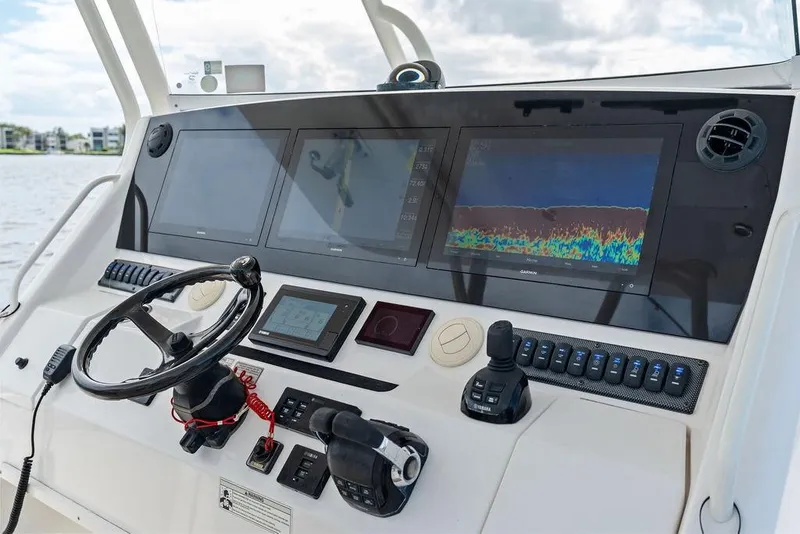 Slide: The Image of Control panel of a 2018 Regulator 41 boat with advanced navigation displays. - 24