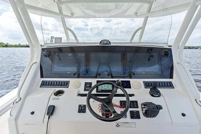 Slide: The Image of Helm of 2018 Regulator 41 boat with advanced navigation controls and displays. - 25
