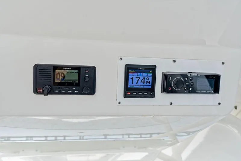 Slide: The Image of 2018 Regulator 41 boat dashboard with Garmin and Fusion marine electronics. - 26