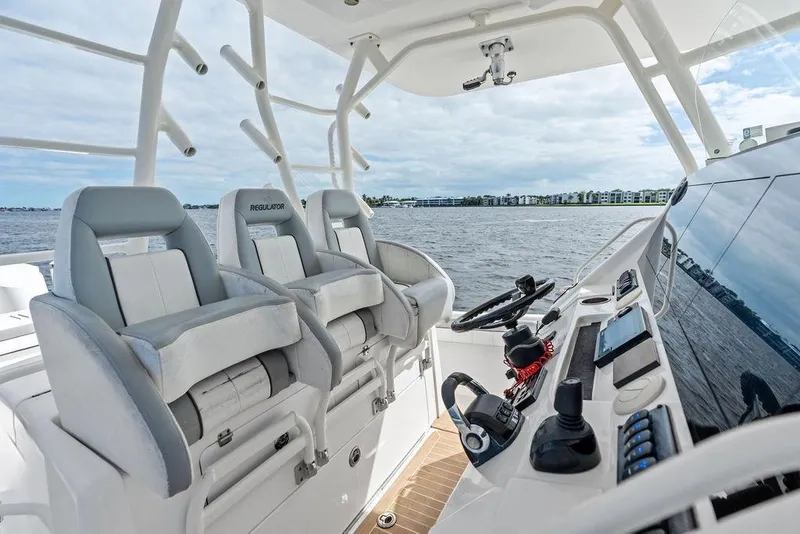Slide: The Image of 2018 Regulator 41 boat cockpit with modern controls and comfortable seating on open water. - 28