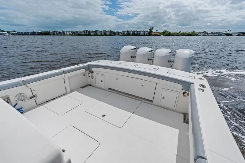 Slide: The Image of 2018 Regulator 41 boat deck with quad engines on a calm waterway. - 29