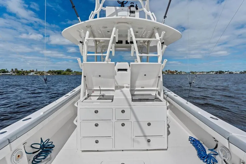 Slide: The Image of 2018 Regulator 41 boat with fishing setup on open water under blue sky. - 31