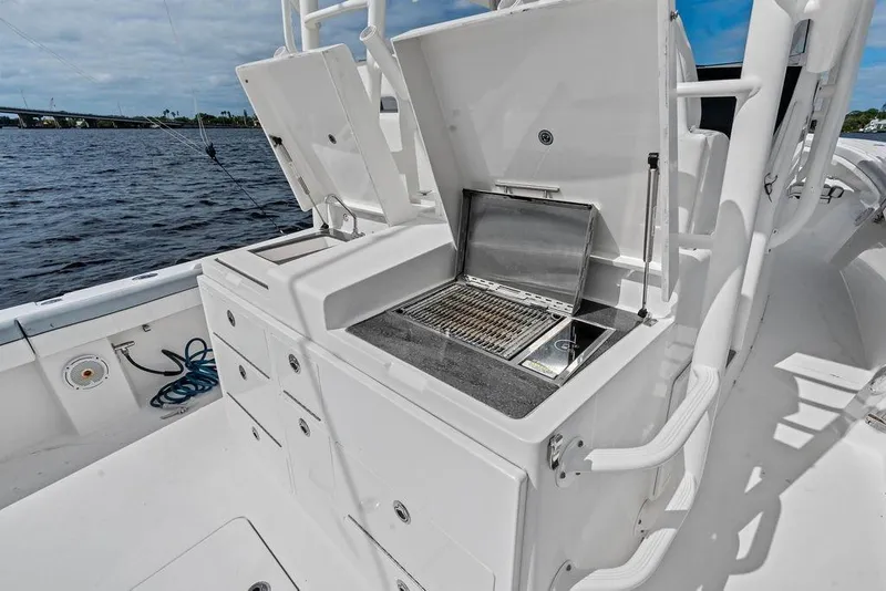Slide: The Image of 2018 Regulator 41 boat with onboard grill and storage, docked by the water. - 33