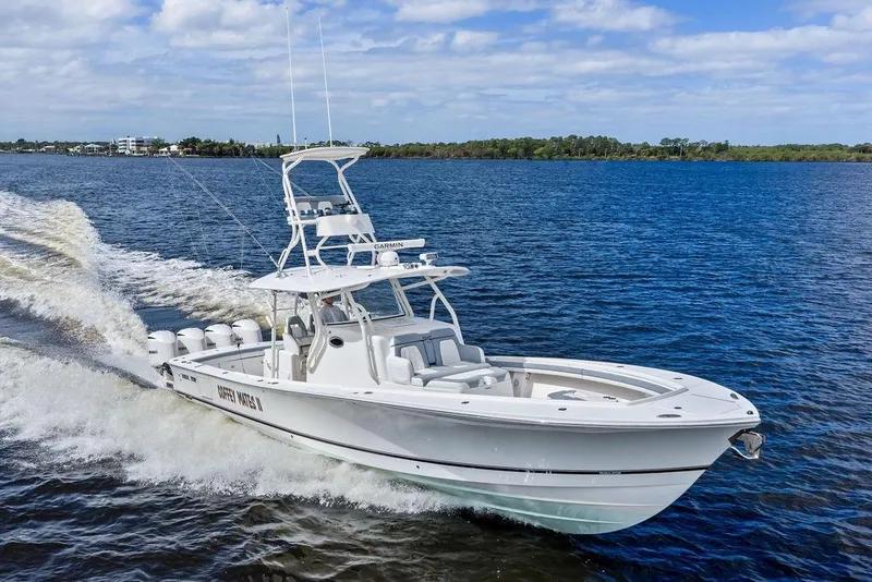 Slide: The Image of 2018 Regulator 41 boat cruising on open water under a clear sky. - 4