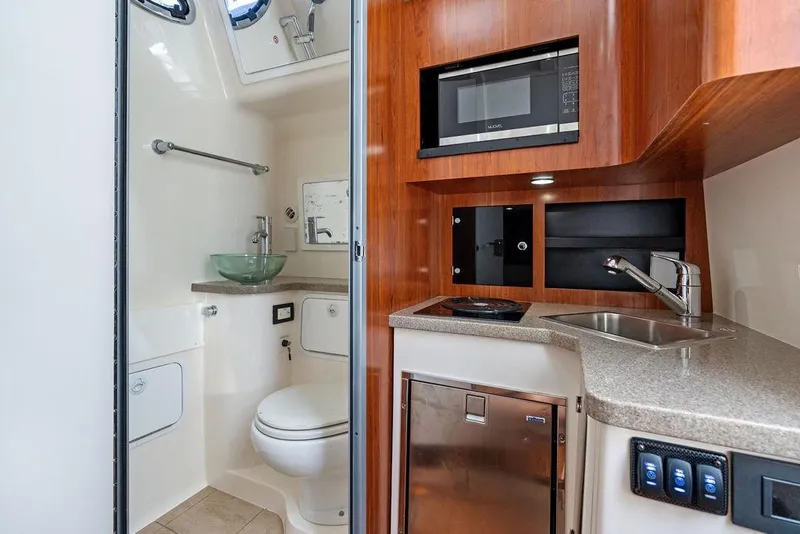 Slide: The Image of 2018 Regulator 41 boat interior with kitchenette and bathroom amenities. - 41