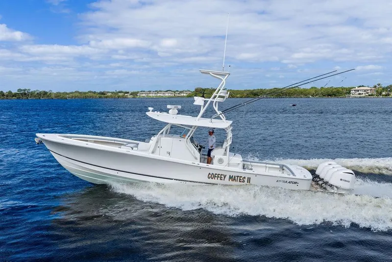 Slide: The Image of 2018 Regulator 41 boat cruising on a lake with clear skies. - 5
