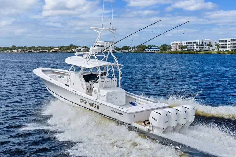 Slide: The Image of 2018 Regulator 41 boat cruising on water with four Yamaha engines. - 6