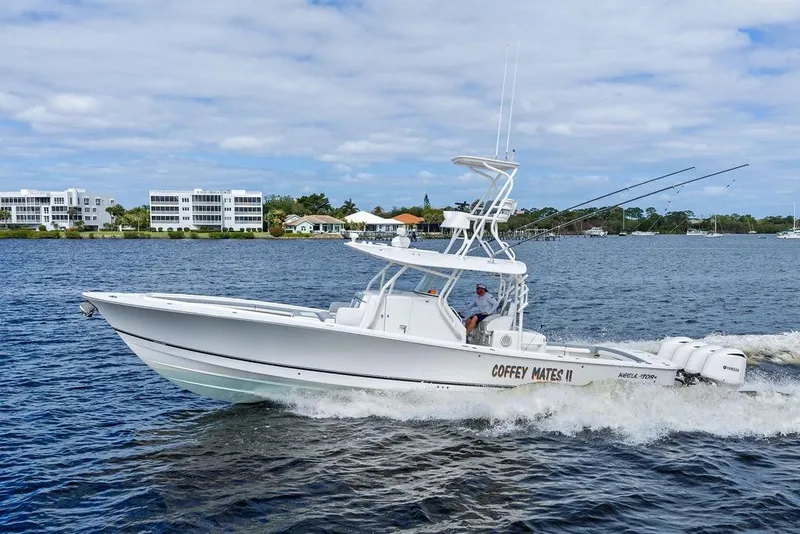 Slide: The Image of 2018 Regulator 41 boat cruising on water with scenic waterfront background. - 7