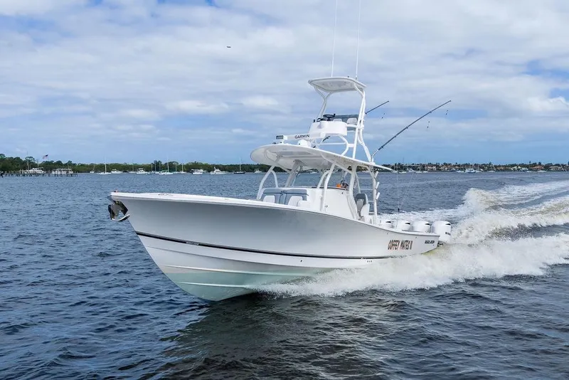Slide: The Image of 2018 Regulator 41 boat cruising on open water under a partly cloudy sky. - 8