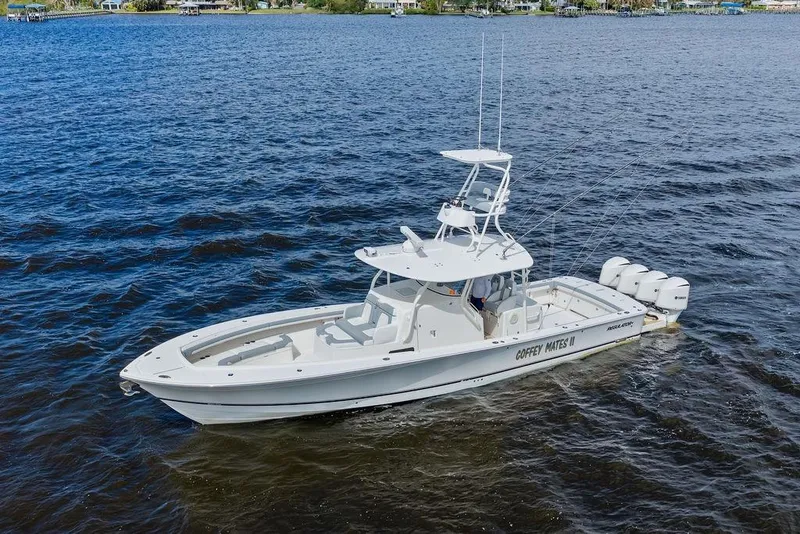 Slide: The Image of 2018 Regulator 41 boat on open water, featuring multiple outboard engines. - 9