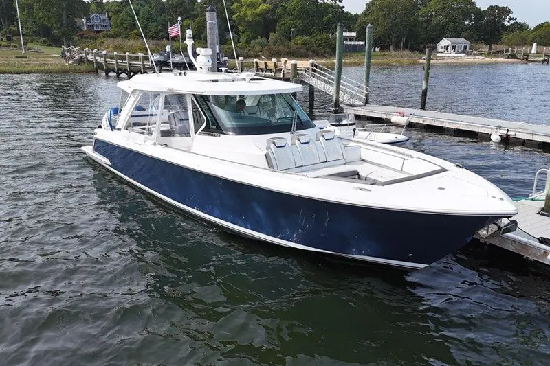 The Image of 2021 Tiara Sport 43 LS boat docked at a marina, featuring sleek design and spacious deck. - 0