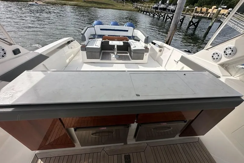 Slide: The Image of 2021 Tiara Sport 43 LS luxury boat interior with seating and outdoor kitchen. - 13