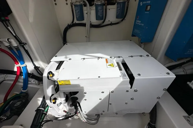 Slide: The Image of Engine compartment of 2021 Tiara Sport 43 LS boat, showcasing electrical components and wiring. - 18