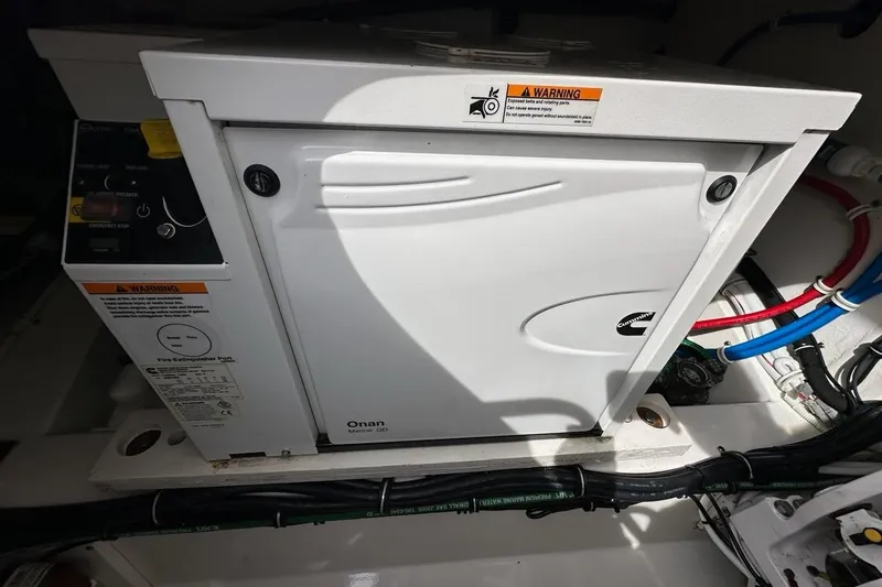 Slide: The Image of Onan Marine generator in a 2021 Tiara Sport 43 LS boat engine compartment. - 19