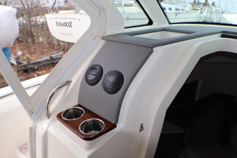 Slide: The Image of 2021 Tiara Sport 43 LS boat interior with cup holders and control panel. - 27