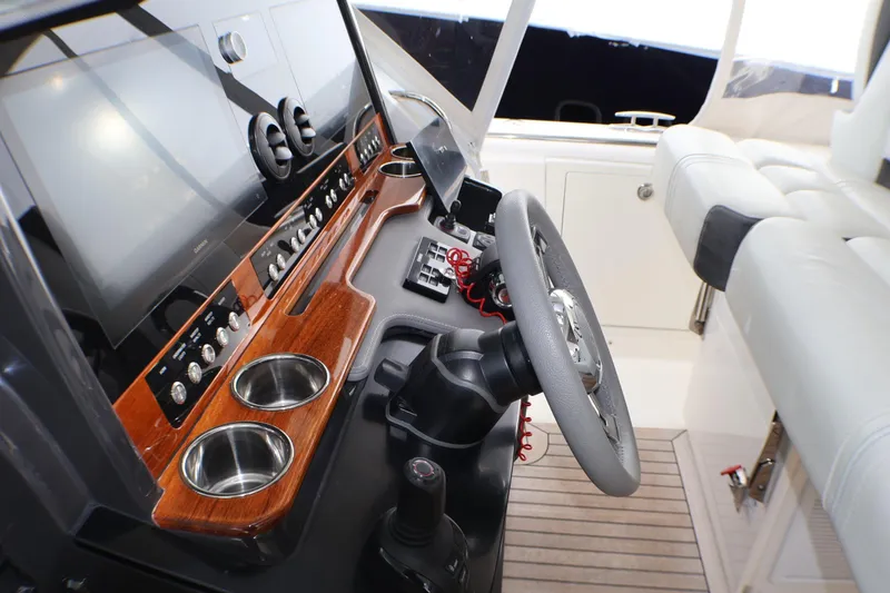 Slide: The Image of 2021 Tiara Sport 43 LS helm with modern controls and luxurious seating. - 29