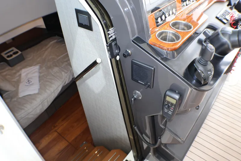 Slide: The Image of Interior view of 2021 Tiara Sport 43 LS yacht, featuring helm controls and cabin entrance. - 30