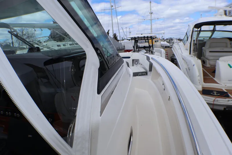 Slide: The Image of 2021 Tiara Sport 43 LS boat docked, showcasing sleek design and spacious deck. - 36