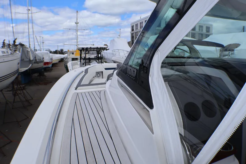 Slide: The Image of 2021 Tiara Sport 43 LS yacht docked, showcasing sleek design and modern features. - 38