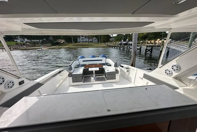 Slide: The Image of 2021 Tiara Sport 43 LS yacht interior with spacious seating and scenic waterfront view. - 49