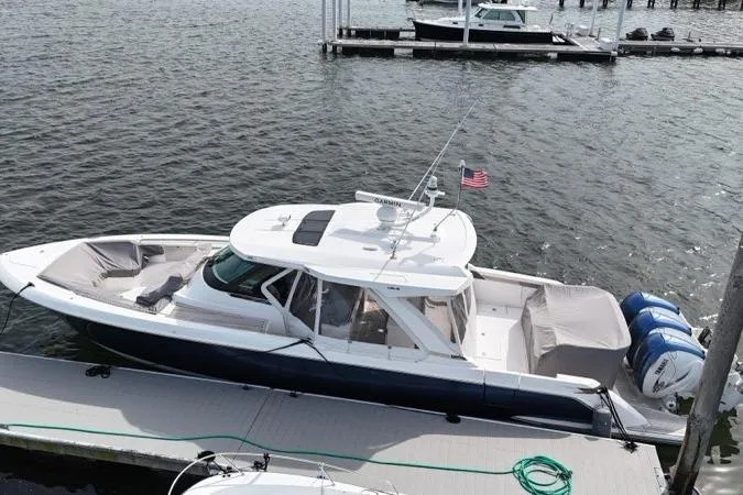 Slide: The Image of 2021 Tiara Sport 43 LS boat docked at marina, aerial view. - 5